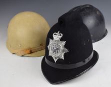 French plastic helmet together with an Argentinean example and a Northumberland Police helmet