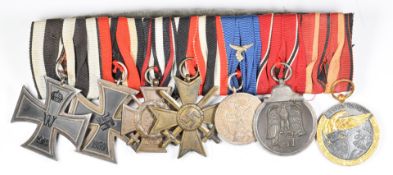 Group of seven German medals comprising WW1 Iron Cross and Cross of Honour with crossed swords,