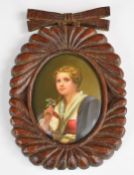 19th / 20thC porcelain oval plaque decorated with a girl holding a flower, in carved wooden frame, 8