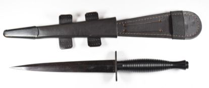 Fairbairn Sykes fighting knife with Sheffield and arrow mark to cross guard, with leather sheath.