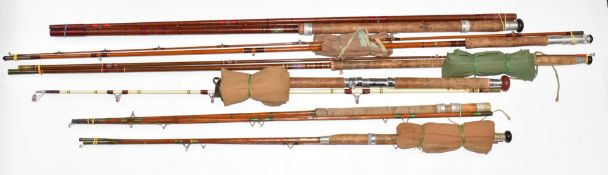 A collection of vintage fishing rods including sea fishing, cane etc