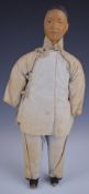 Chinese 'Door of Hope' doll wearing a pale blue (faded) trousers and jacket, with carved bun