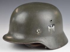 German M35 steel helmets stamped 708 and ET66 to inner rim, with leather liner and chin strap