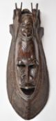 Large African tribal mask with adzed decoration and antelope finials, height 77cm