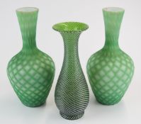 Three Stourbridge glass vases comprising a pair of quilted air trap satin bottles vases (21.5cm