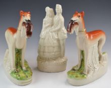 A pair of Staffordshire greyhounds with game, height 28cm and a figure of a soldier with sweetheart