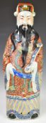 Chinese ceramic figure of a deity, in a kimono holding a ruyi, with impressed seal mark to base,