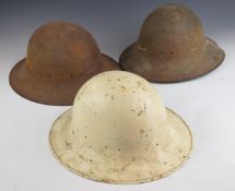 Three civil defence 'Zuckerman' helmets, two dated 1941 and one with liner