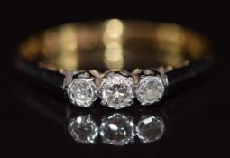 An 18ct gold ring set with three diamonds in a platinum setting, 2.3g, size Q,