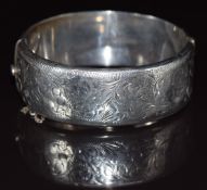 Silver bangle with engraved scrolling decoration