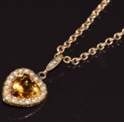 Edwardian 9ct gold pendant in the form of a heart set with a citrine surrounded by seed pearls, on