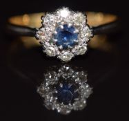 An 18ct gold ring set with a sapphire surrounded by diamonds, 3.1g, size O