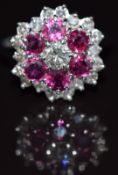 An 18ct white gold ring set with a diamond of approximately 0.3ct surrounded by rubies and a further