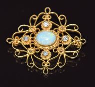 An 18ct gold filigree brooch set with an oval opal cabochon and four diamonds, 6.6g 3.2cm