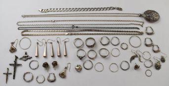 A collection of silver earrings, chains, rings, and lockets