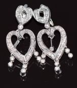 A pair of white gold earrings set with diamonds in the form of two hearts, 9g 4x1.5cm