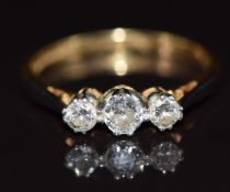 An 18ct gold ring set with three diamonds in a platinum setting, in vintage box, 2.1g, size L