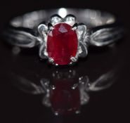 A 9ct white gold ring set with an oval cut ruby, 3.4g, size N