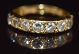 An 18ct gold half eternity ring set with seven round cut diamonds, each approximately 0.08ct, 2.