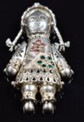 A silver pendant in the form of a rag doll