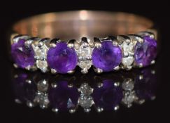 A 9ct gold ring set with round cut amethysts and diamonds, 1.9g, size M