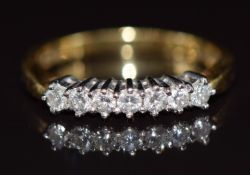 An 18ct gold ring set with seven diamonds, the total diamond weight approximately 0.33ct, 3.9g, size