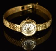 Omega 18ct gold ladies wristwatch with black hands, baton hour markers, silver dial and mechanical