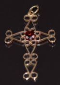 A 9ct gold pendant in the form of cross set with a garnet, 2.3g