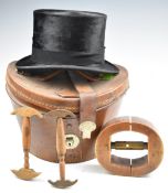 Silk top hat by Battersby and Co, London, in leather case with three vintage hat stretchers