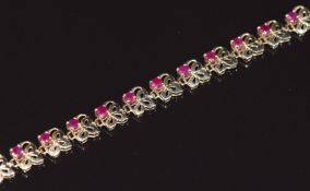 A 9ct gold bracelet set with rubies in a foliate design, 5.2g 20cm
