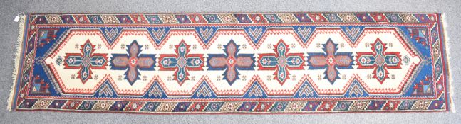 A wine ground runner with central row of guls, 317 x 74cm