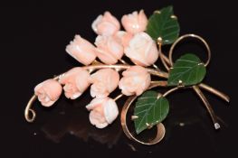 An 18k gold brooch set with carved coral roses and nephrite jade leaves, 19g 6.5x5cm