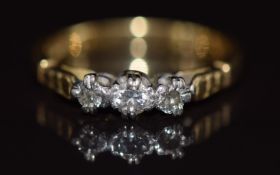 An 18ct gold gold ring set with three diamonds in a platinum setting, 3.1g, size K
