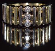 A 14k gold bi-coloured ring set with three diamonds, 9.7g, size T