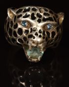 A silver ring in the form of a leopard set with blue paste to eyes and mouth, 15.8g, size U