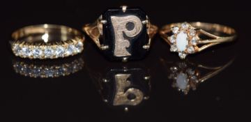 Three 9ct gold rings, one set with an opal and cubic zirconia, one withcubic zirconia and the