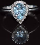 A 9k white gold ring set with a pear cut topaz surrounded by diamonds, 2.6g, size N