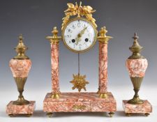 Varigated red marble French clock garniture, the movement marked A Paris and with gold medal mark,