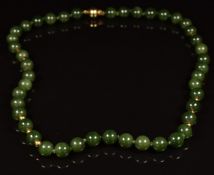A necklace of nephrite jade and gold beads with 18ct gold clasp