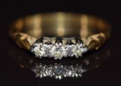 An 18ct gold ring set with three diamonds in a platinum setting, 2.8g, size O