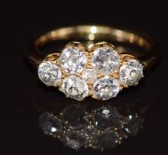A late Victorian ring set with seven old cut diamonds, the total diamond weight approximately 1.4ct,
