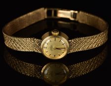 Omega 9ct gold ladies automatic wristwatch with black hands, baton hour markers, gold dial and