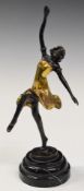 Bronze figure of an Art Deco dancer raised on a circular stepped marble plinth, after Ferdinand