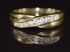 A 14k gold ring set with cubic zirconia in a twist setting, 2.4g, size N