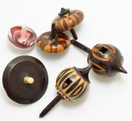 Six 19thC spinning tops comprising four Tunbridge ware, one glass and a treen example with carved