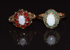 Two 9ct gold rings one set with an opal surrounded by emeralds, the other with an opal surrounded by