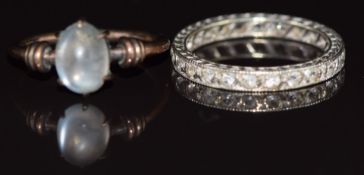 A 9ct white gold eternity ring set with spinel and a 9ct gold ring set with a moonstone, 3.5g,