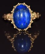 A 9ct gold ring set with a lapis lazuli cabochon, 5.4g, size N