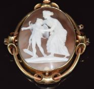 Victorian yellow metal brooch set with a cameo depicting a classical woman with Eros or Cupid, in