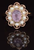 A 9ct gold ring set with an oval cut amethyst surrounded by split pearls, 4.1g, size O